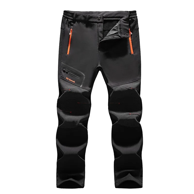 Black hiking pants with orange zipper pockets and reinforced knee padding.”,